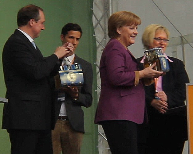 Všechno nejlepší! Německá kancléřka Angela Merkel obdržela balíček slavného piva Flensburger. (2012)